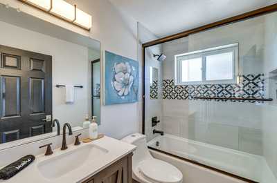 Relax in the cozy ambiance of this well-appointed bathroom, perfect for unwinding after a long day.