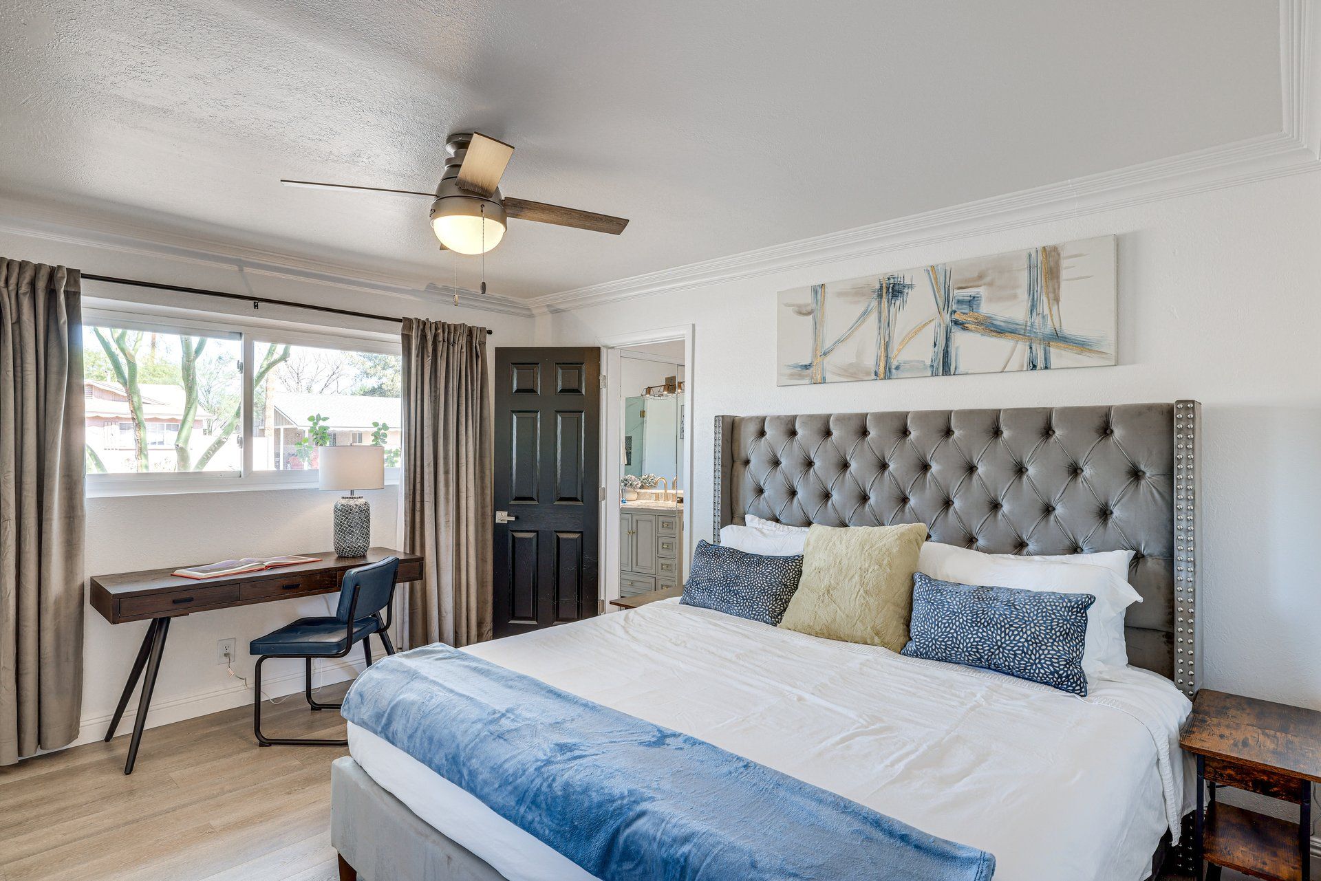 image Rest easy in a cozy bedroom, complete with stylish decor and a workspace for your convenience.