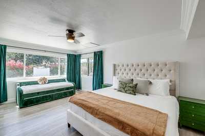 Relax in this bright master suite, featuring a plush king bed and luxurious decor.