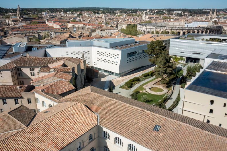 image Aerial view of the hotel nestled among Nîmes' historic rooftops, steps from the Arènes and the city's Roman landmarks.