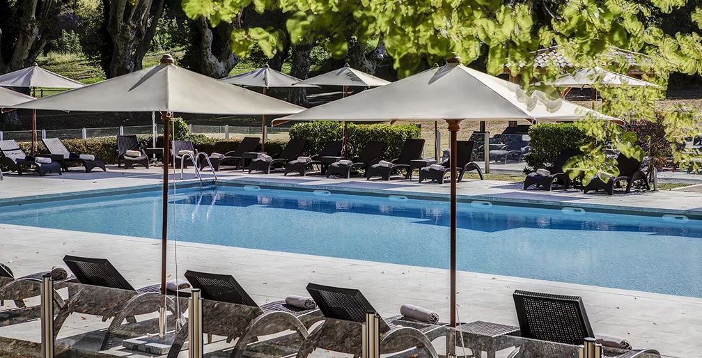 image Spacious sun terraces border the pool, offering the perfect spot to relax under the Provence sky after a round on the estate's award-winning golf course.
