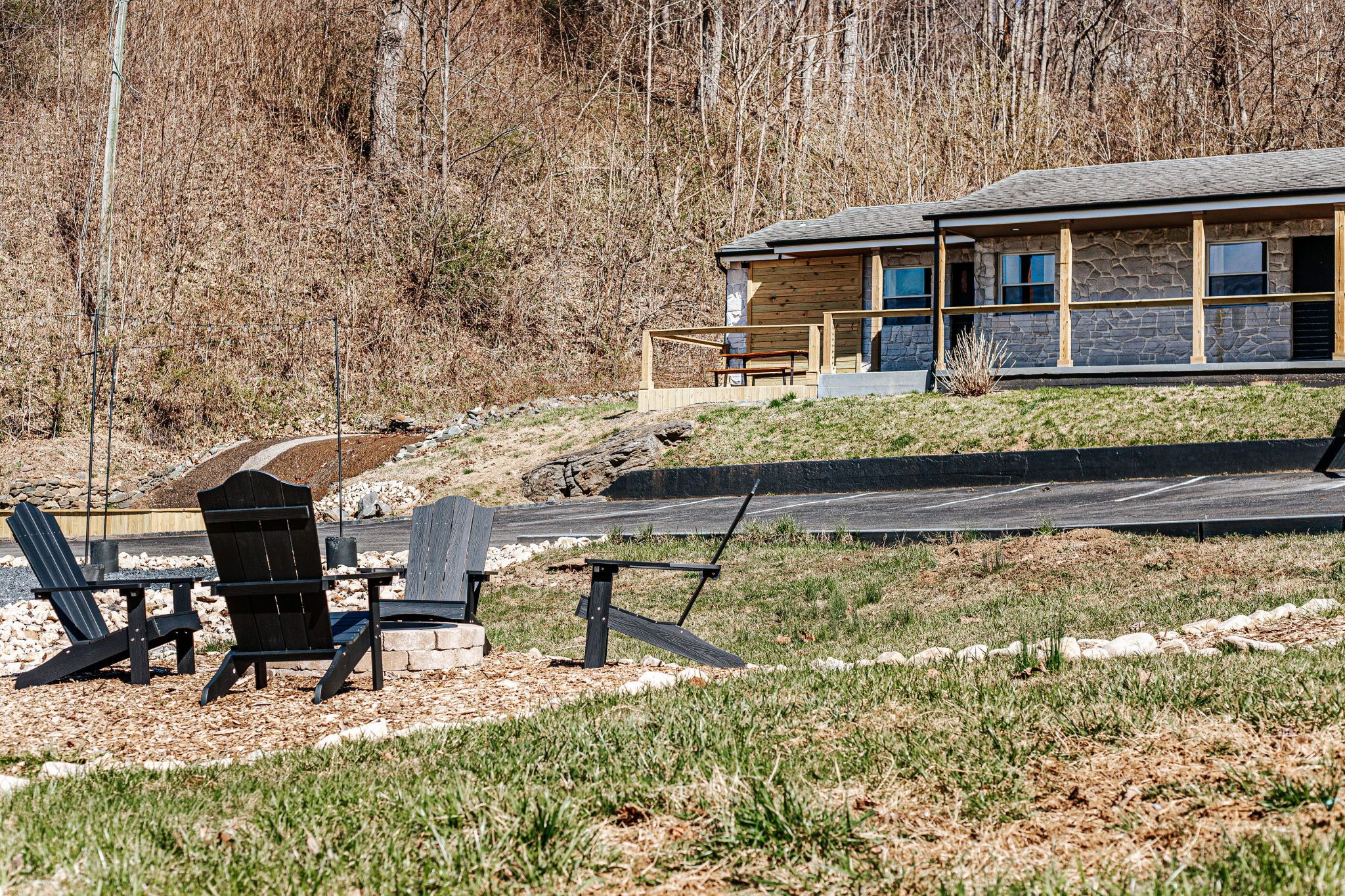 image Gather around the fire pit in cozy Adirondack chairs, perfect for relaxing under the stars.