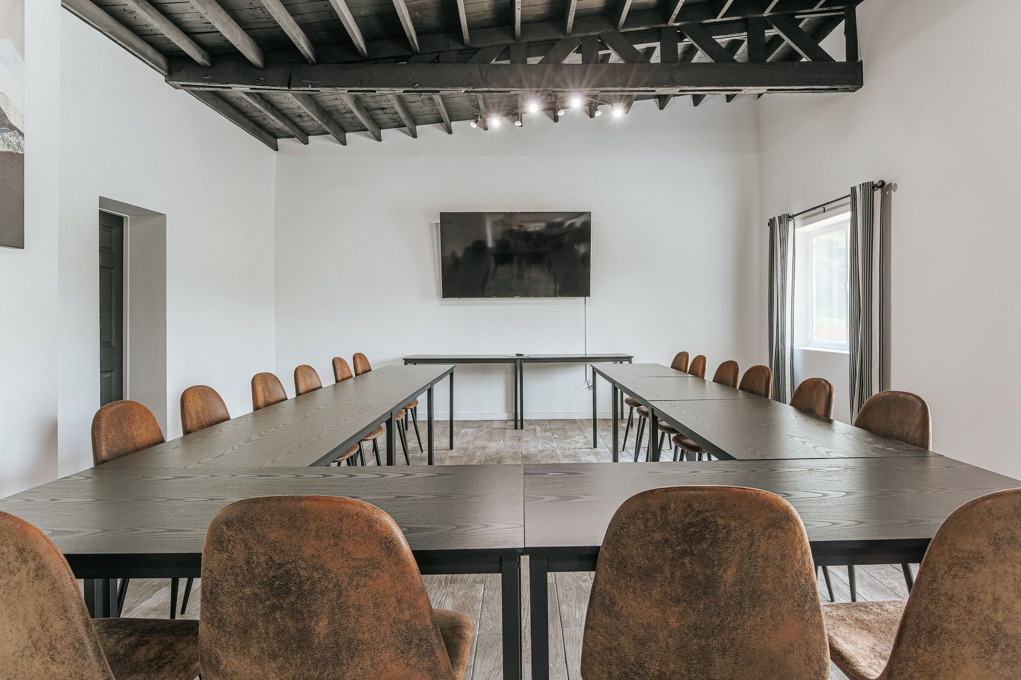 image Host your next meeting in this stylish space, equipped with a large screen for seamless presentations.