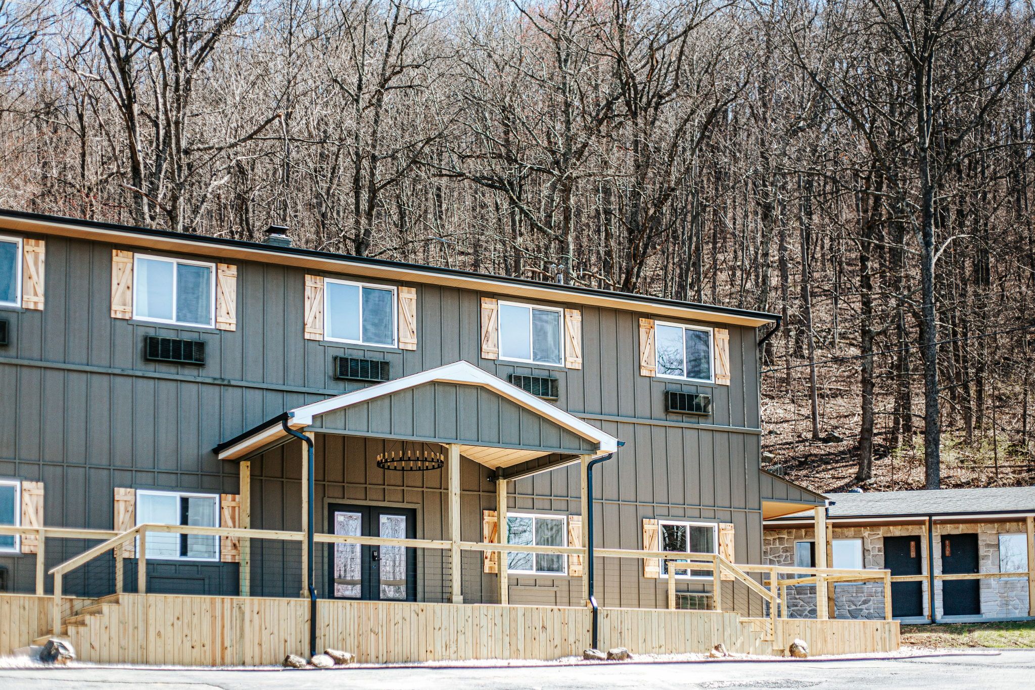 image Experience a welcoming exterior set against a serene backdrop of bare trees. Nature is just a step away.
