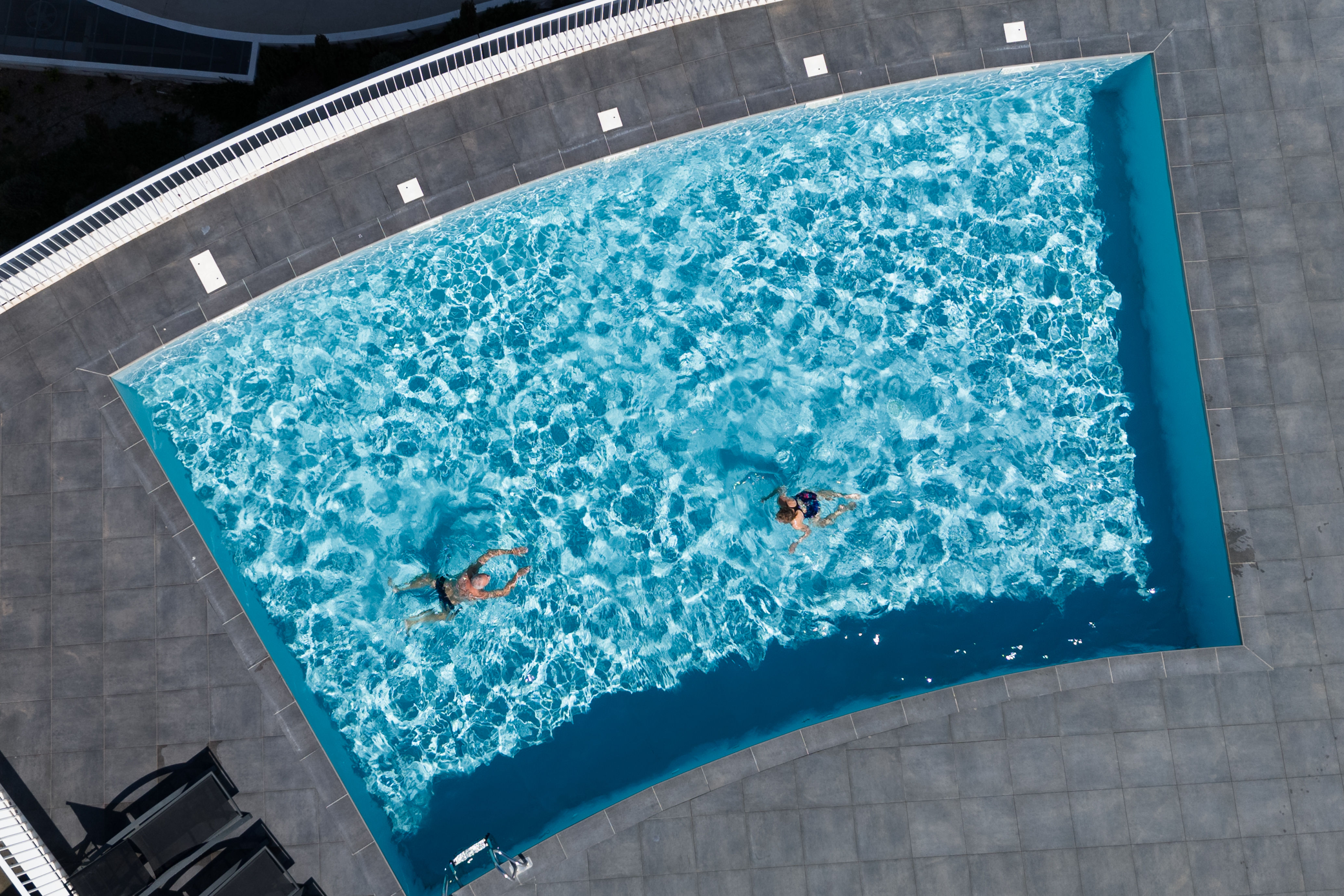 image The rooftop heated pool seen from above — open April through October, with turquoise water and a sun-drenched tile deck.