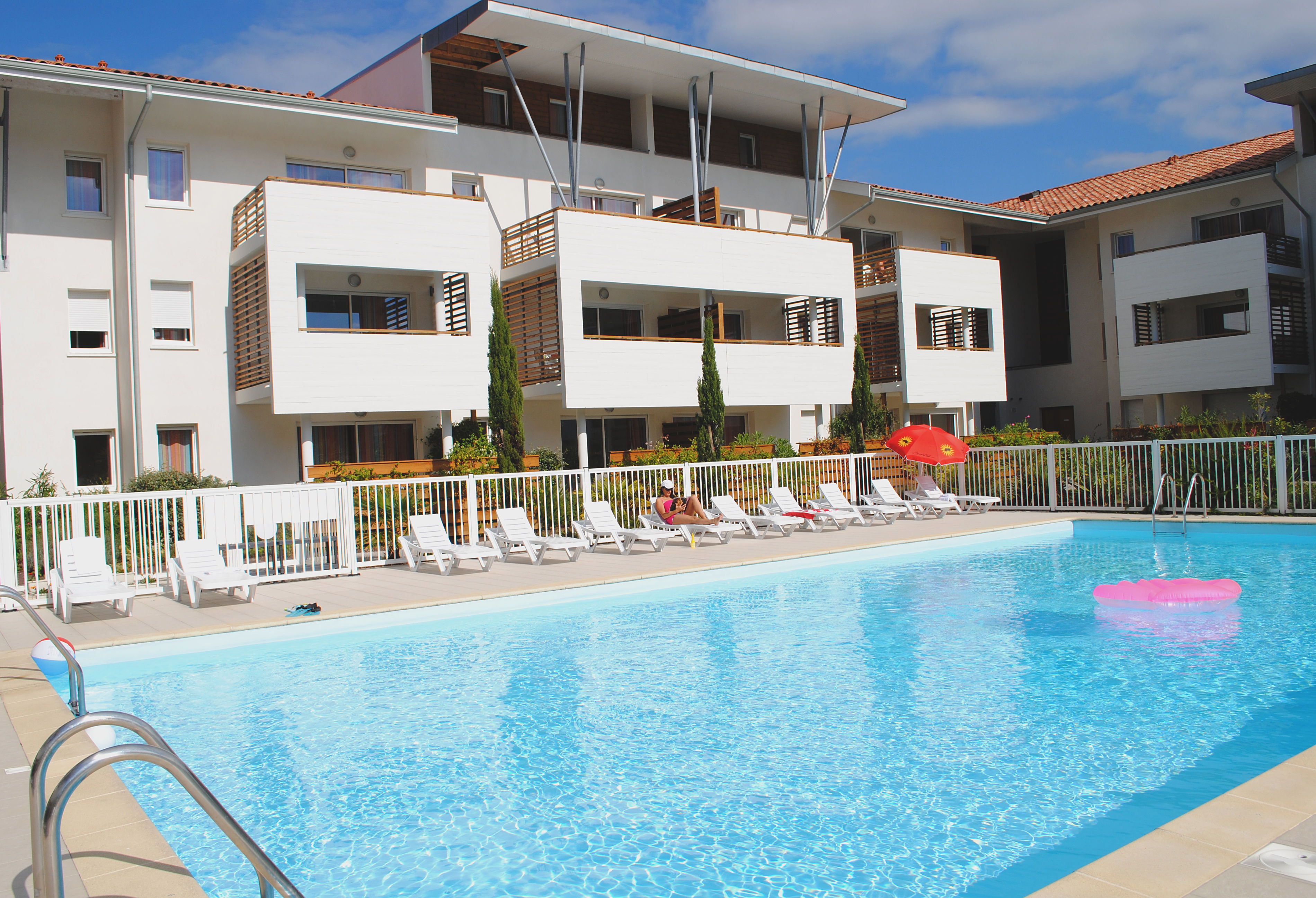 image The outdoor pool is the heart of summer stays, surrounded by sun loungers and open skies.