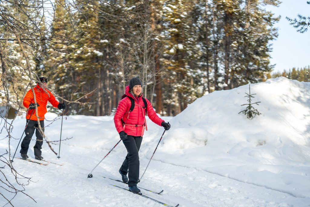 image Glide along the snowy trail with friends, your laughter echoing through the peaceful winter landscape.