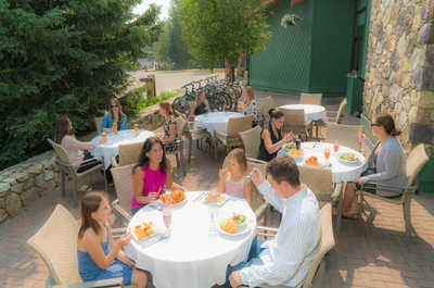 Share laughter and great food in a charming outdoor dining space, ideal for memorable gatherings.