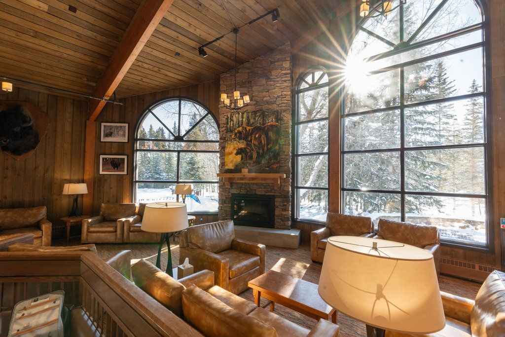 image Unwind in a spacious lounge, basking in natural light that dances through large windows.