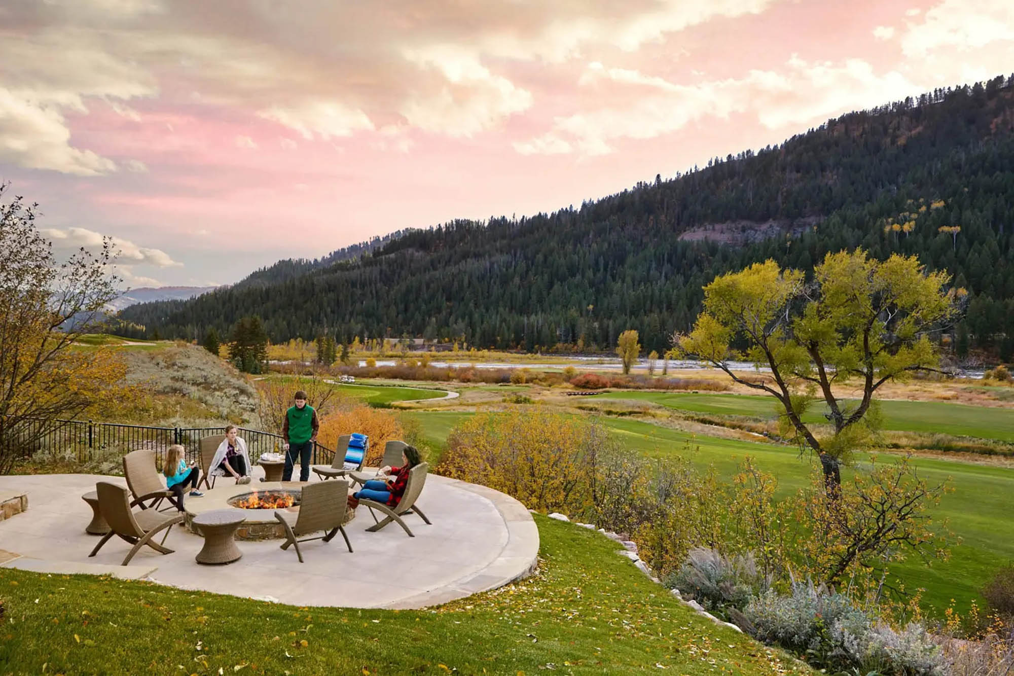 image Around the fire pit as the sun drops behind the Tetons — evenings here tend to stretch long