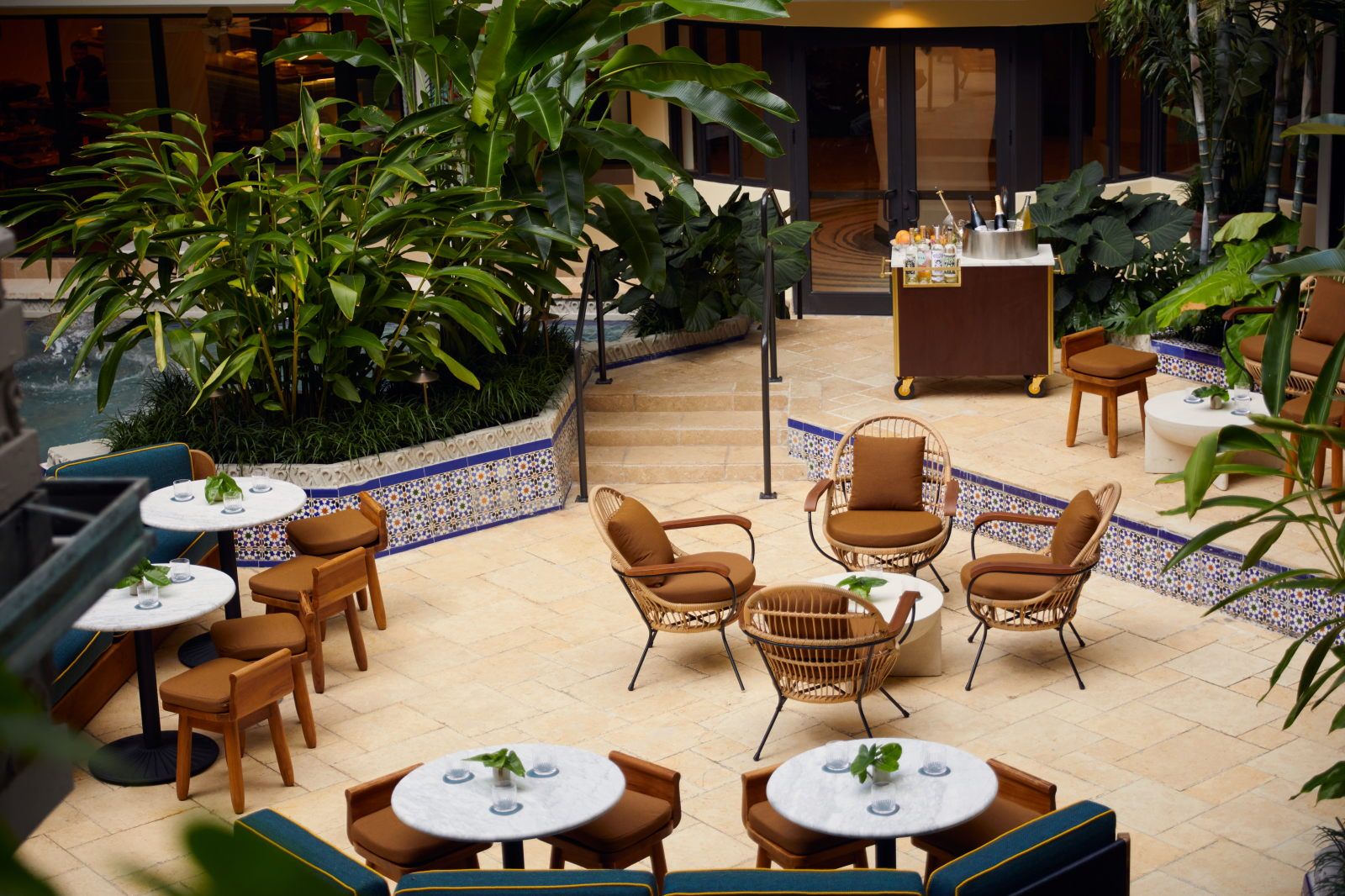 image Unwind at the fountain lounge, where the sound of water complements a drink among tropical plantings