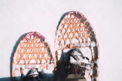 Snowshoes press fresh tracks into a snow-packed trail near Jackson Hole.