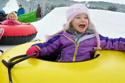 Families race down the tubing hill at Snow King Mountain.