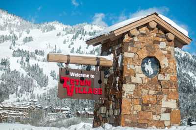 Wooden entry signs welcome visitors into Teton Village at the base of the mountain.
