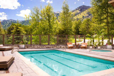 Summer transforms the outdoor pool into a mountain-view swim spot.