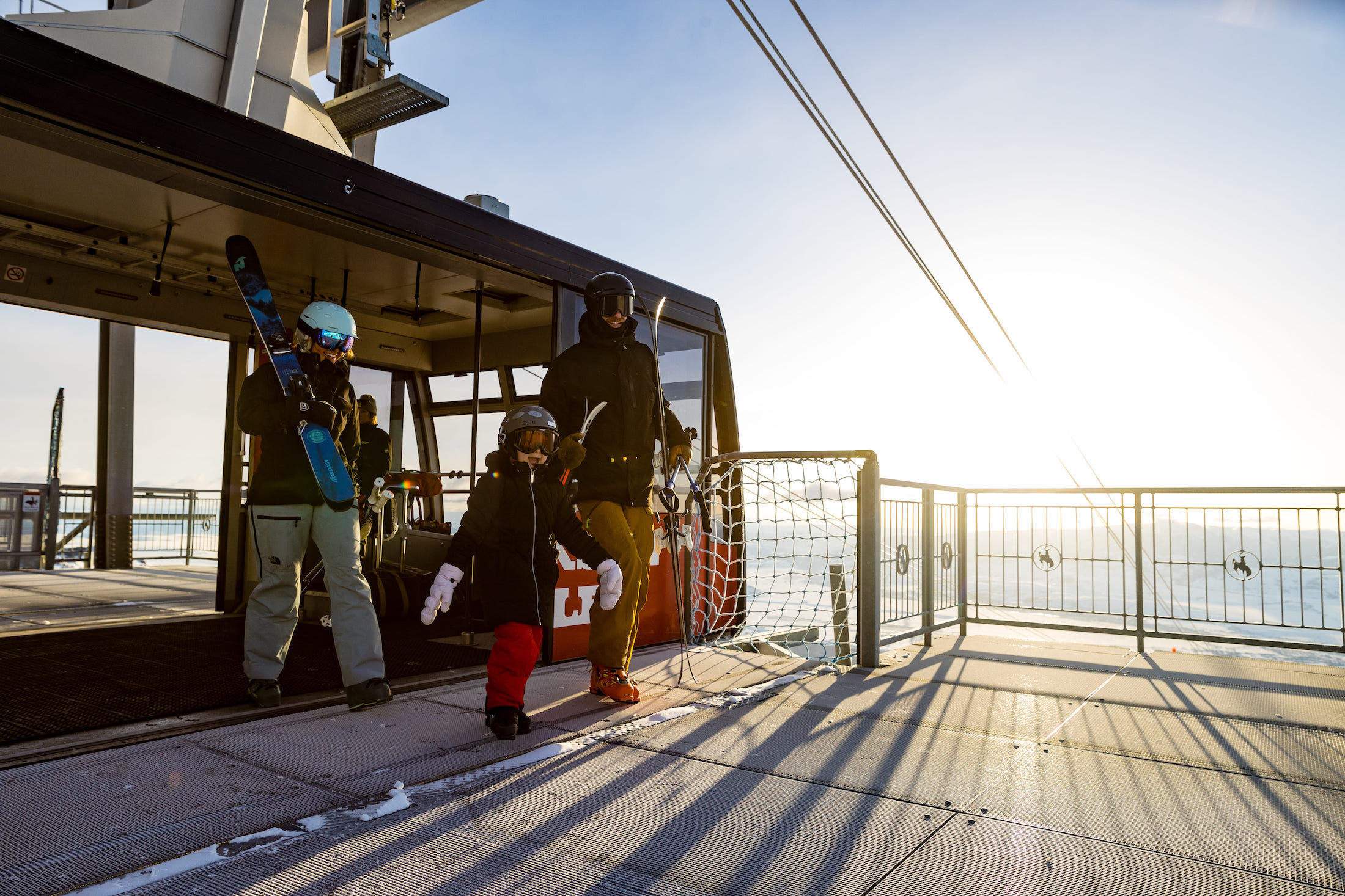 image Skis in hand, one family steps off the tram at the summit.