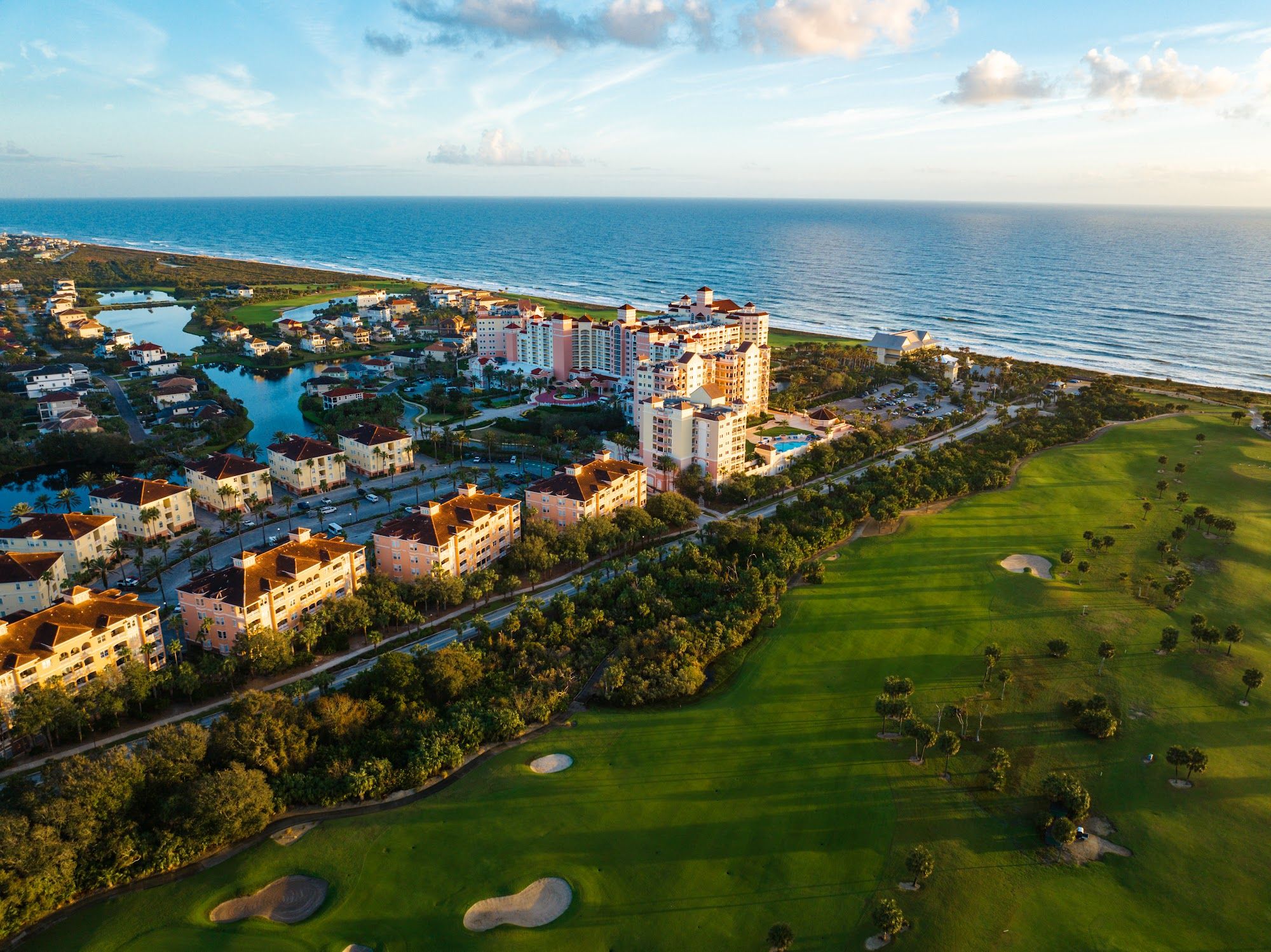 image Aerial view of the resort complex with hotel tower, golf courses, and ocean beyond