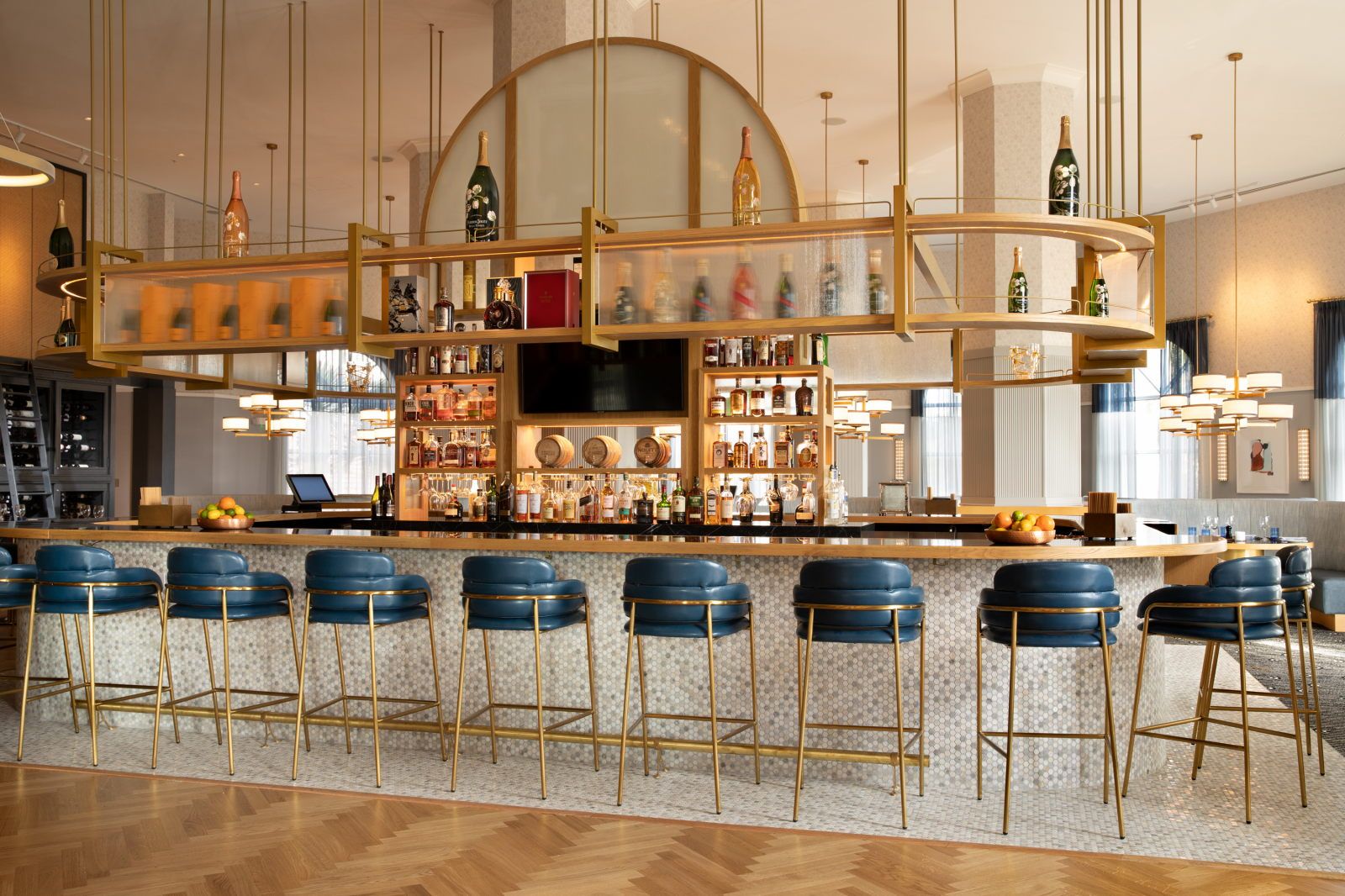 image Circular bar counter with tall stools and backlit shelves of spirits