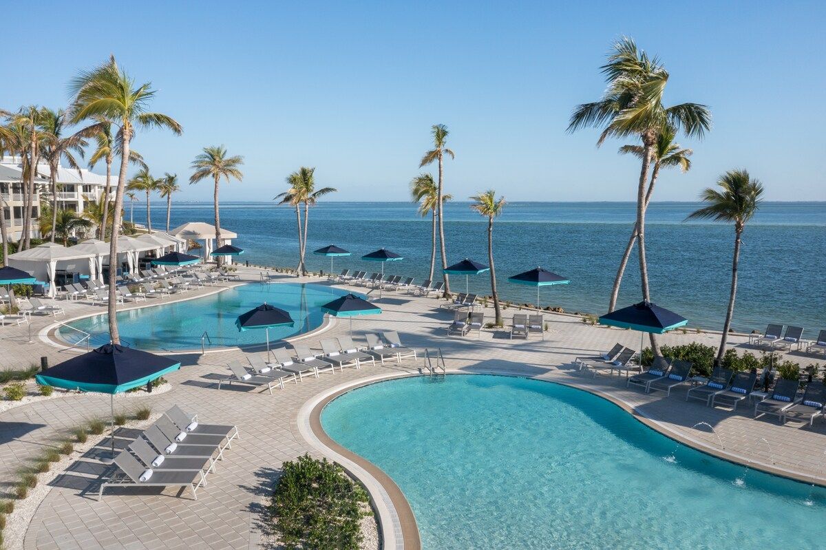 image Get a bird's-eye look at the pool complex, its blue water framing the palm-lined resort grounds below.