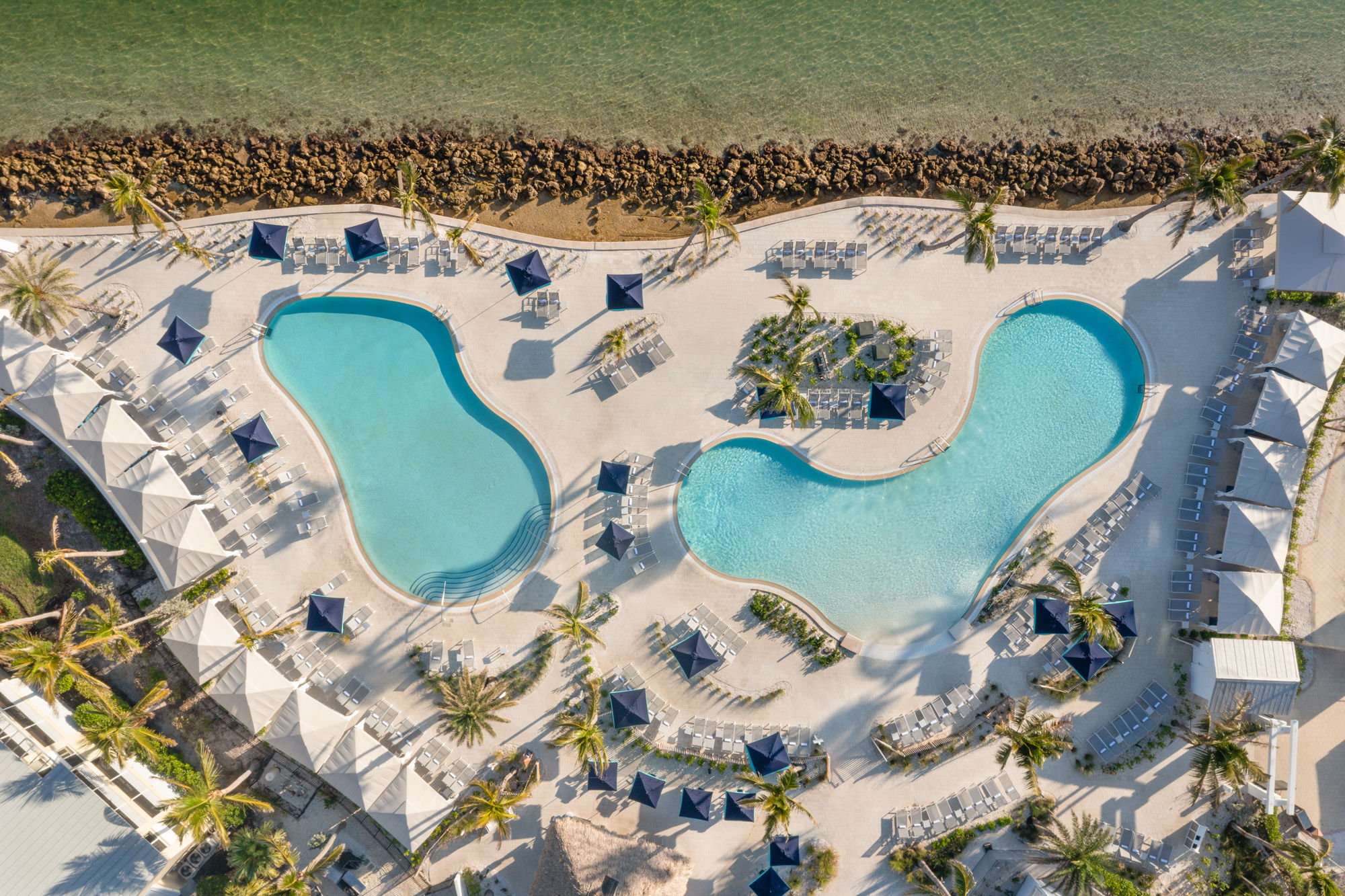 image Cabanas and poolside seating line the deck, offering shade between swims.