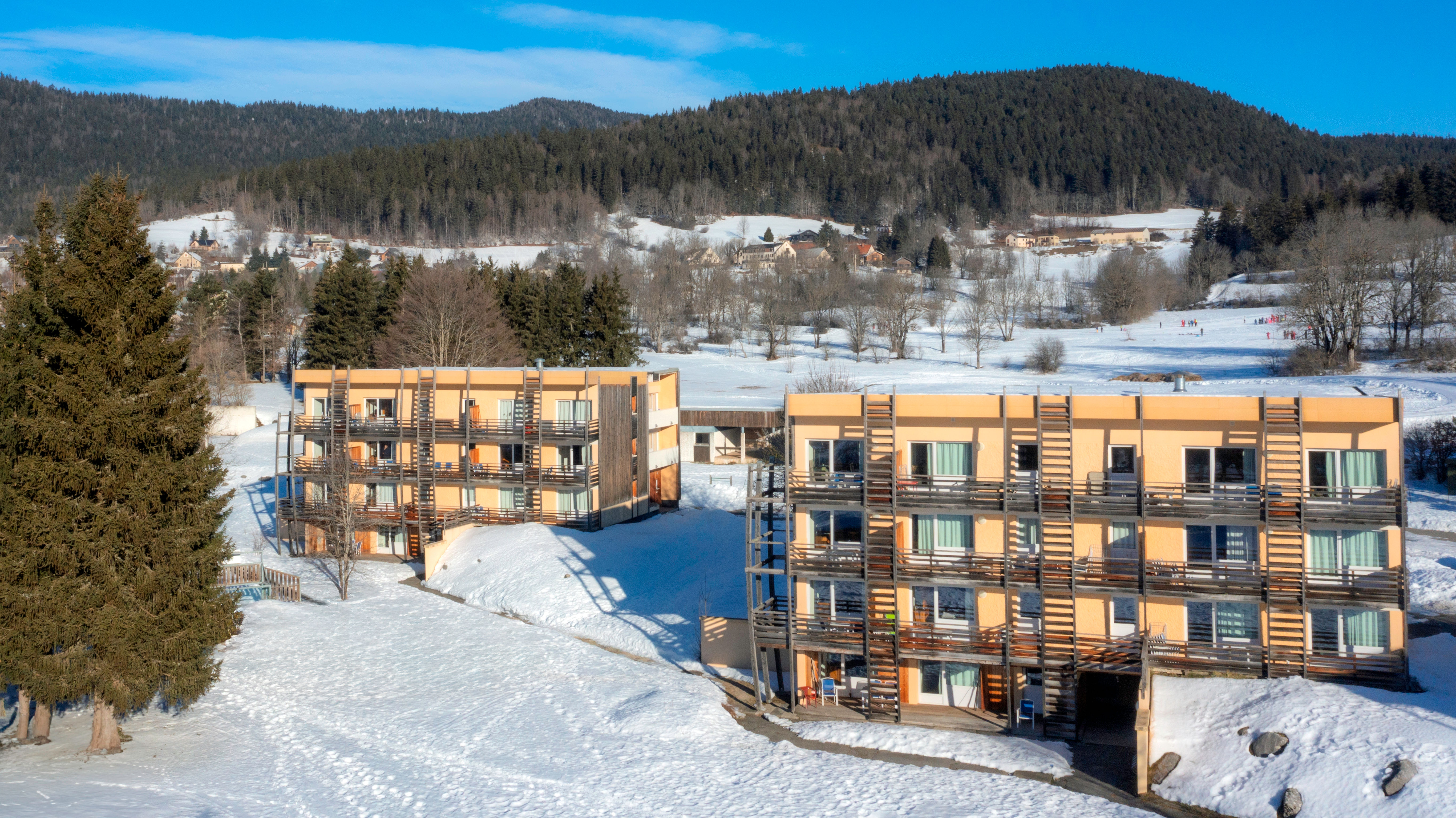 image Wake up to residence buildings framed by forested Vercors hills.