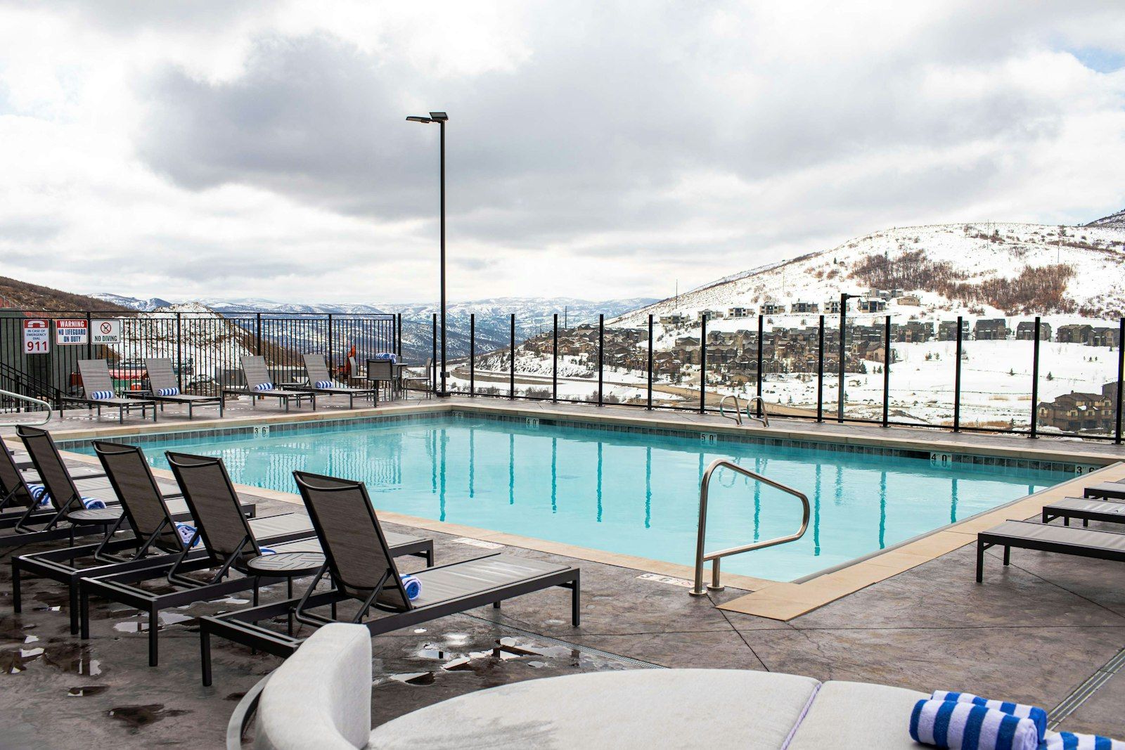 image Outdoor poolside with loungers and snowy mountain backdrop