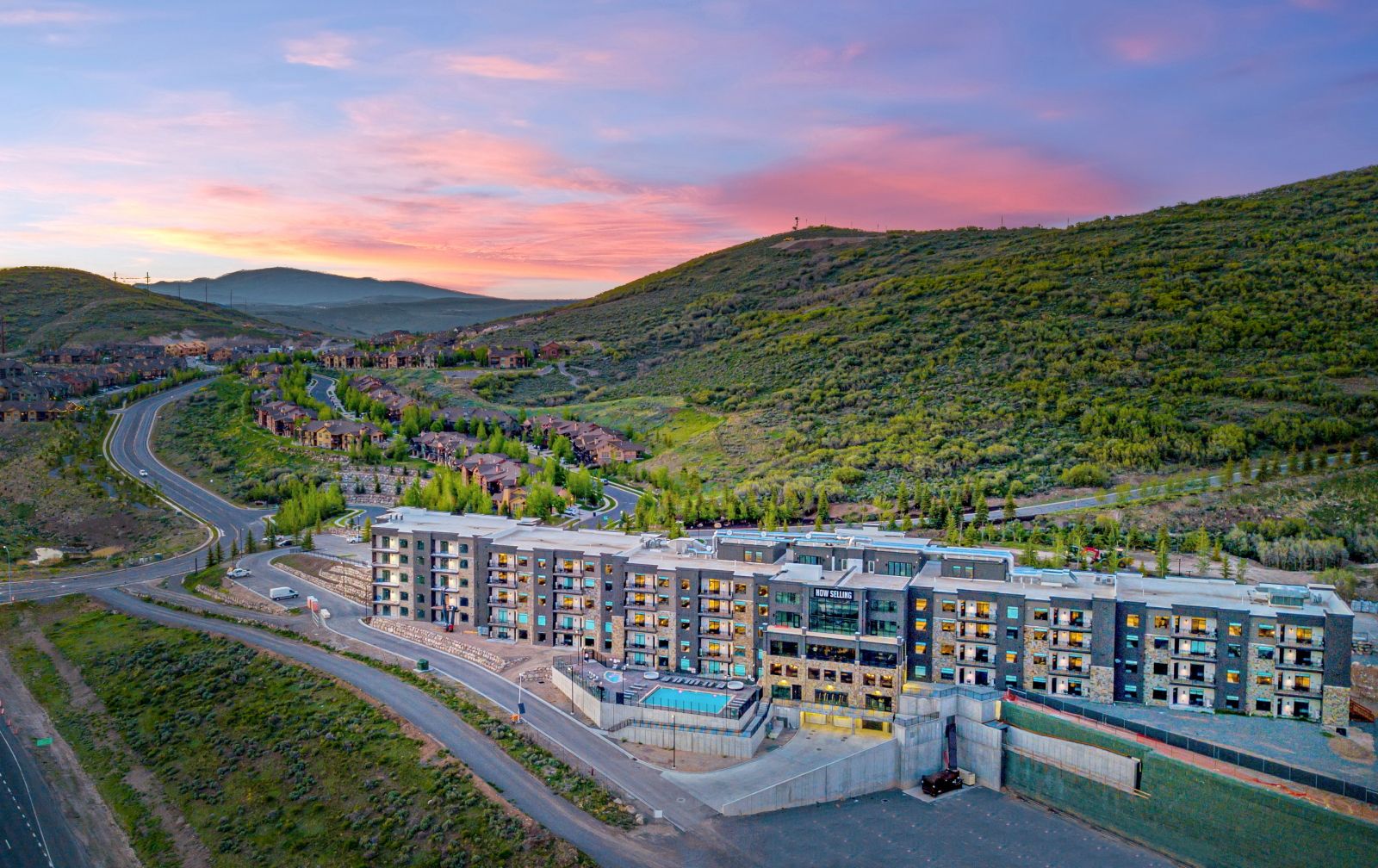 image Resort buildings nestled against forested mountain slopes