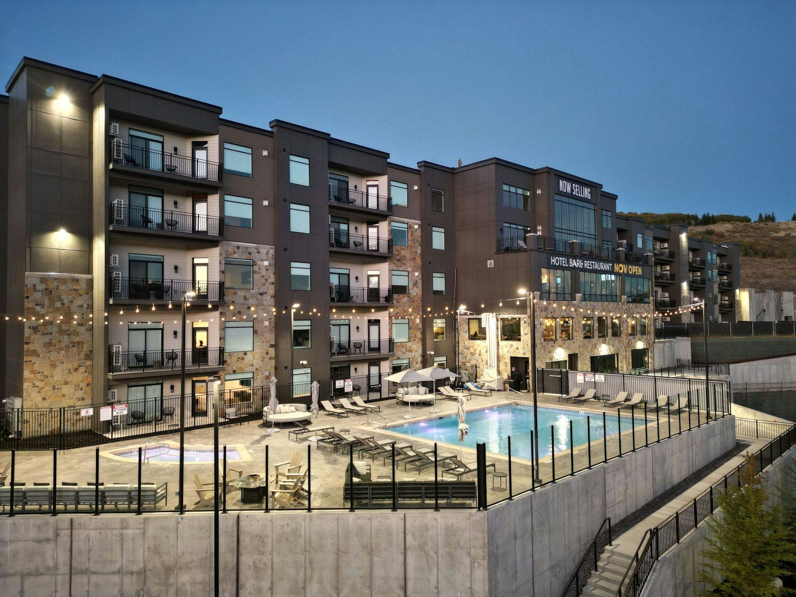 image Modern resort exterior with a pool area and balcony views