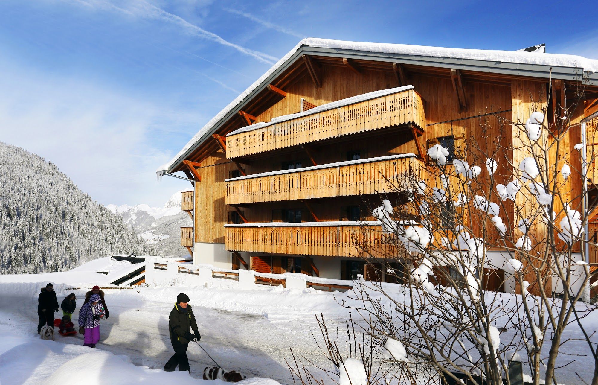 image Wooden building with balconies and people walking in snow