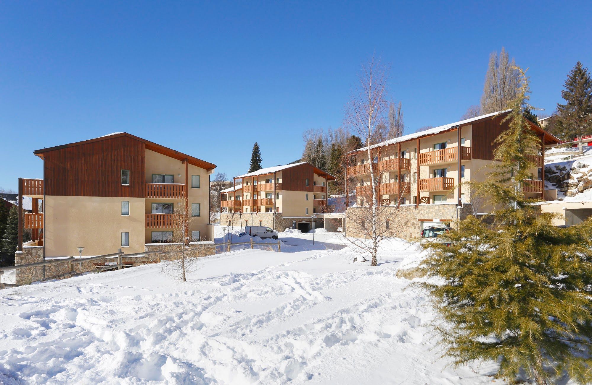 image Three accommodation blocks stepping up the hillside in winter snow