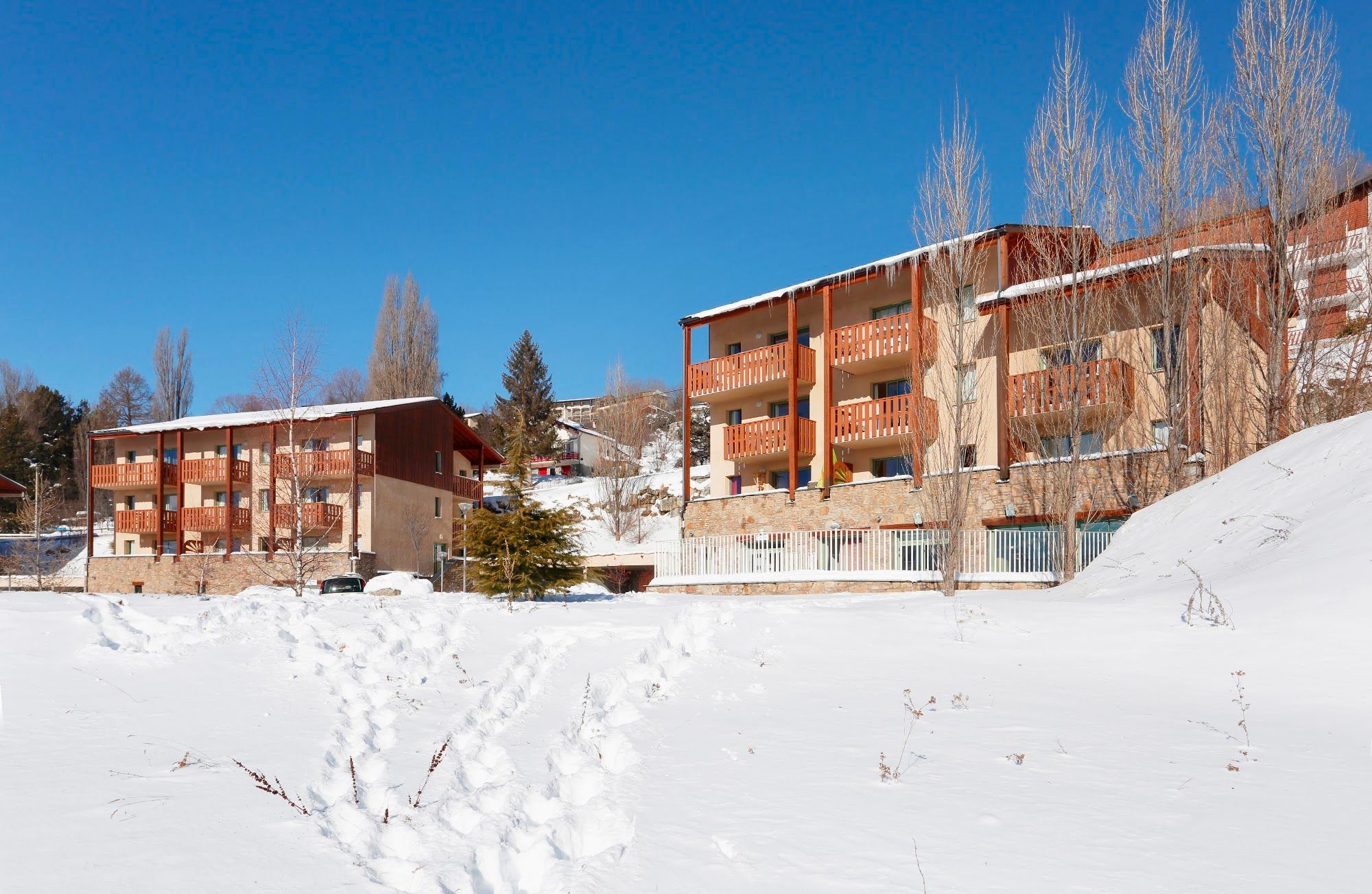 image Timber-clad alpine buildings with slate roofs under deep winter snow