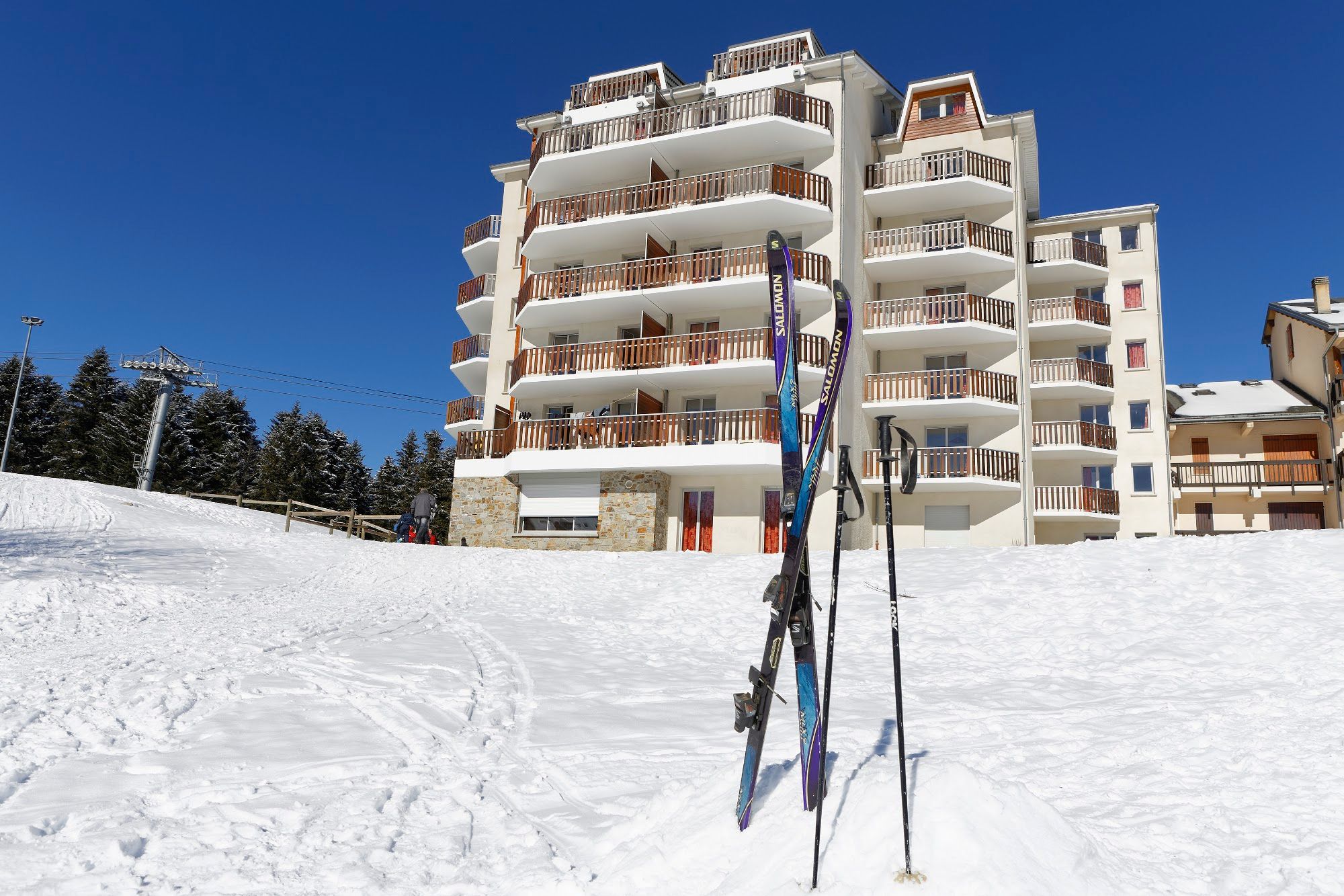 image A residence framed by piste and powder, ready for the day's first run.