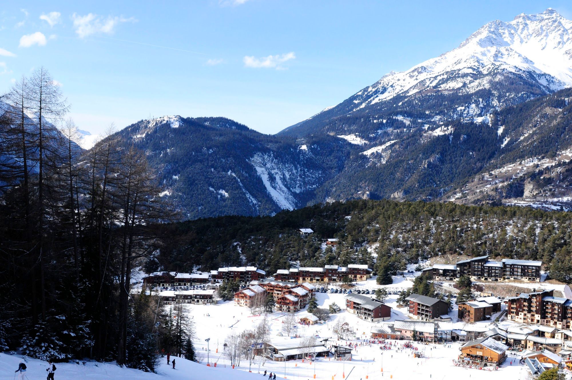 image Elevated view across the village and valley to snow-covered peaks