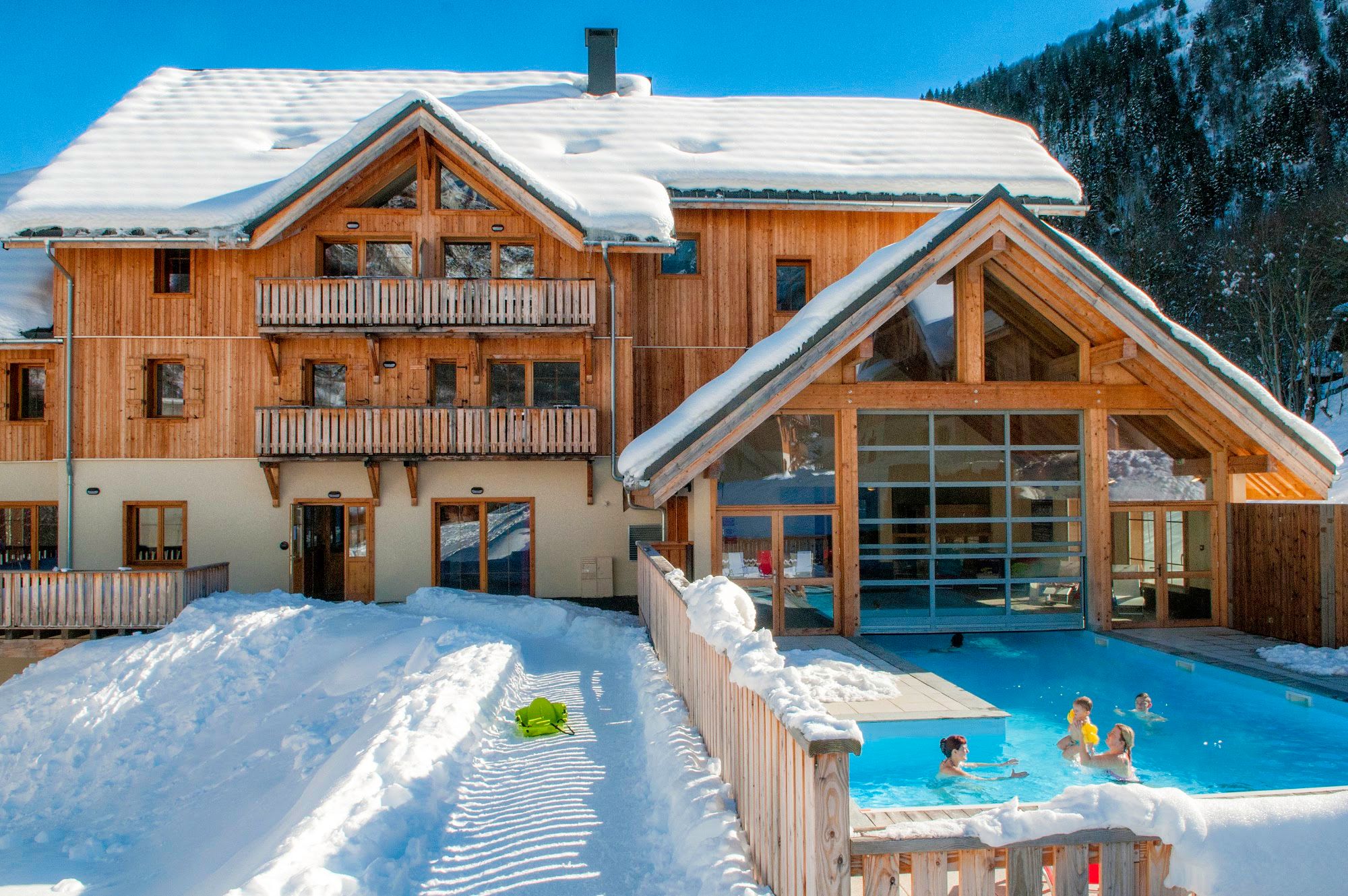 image Building with a snow-covered roof and an outdoor pool