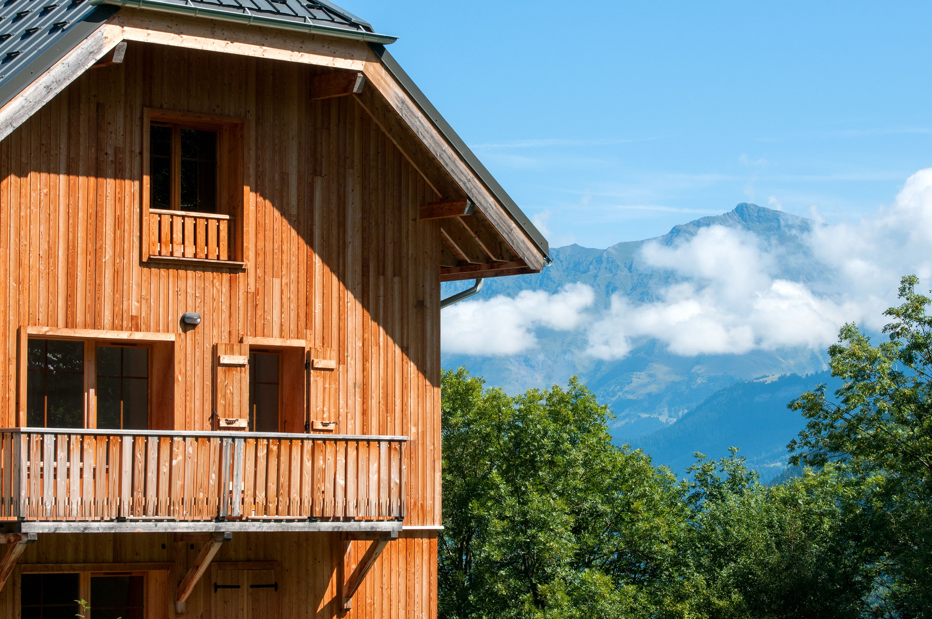 image Balconies look out over the trees toward the distant peaks.