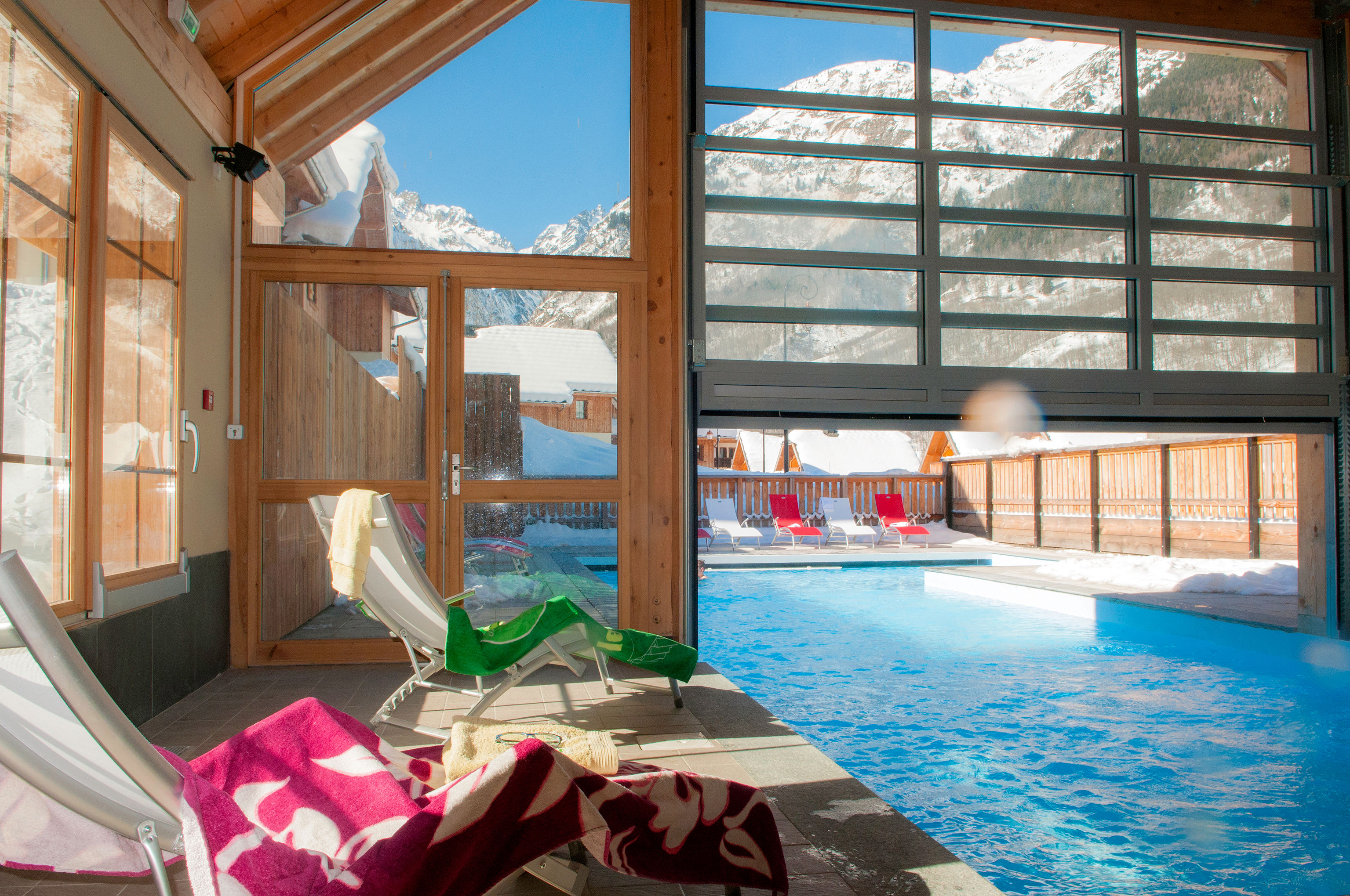 image Indoor pool with mountain and wooden architecture views