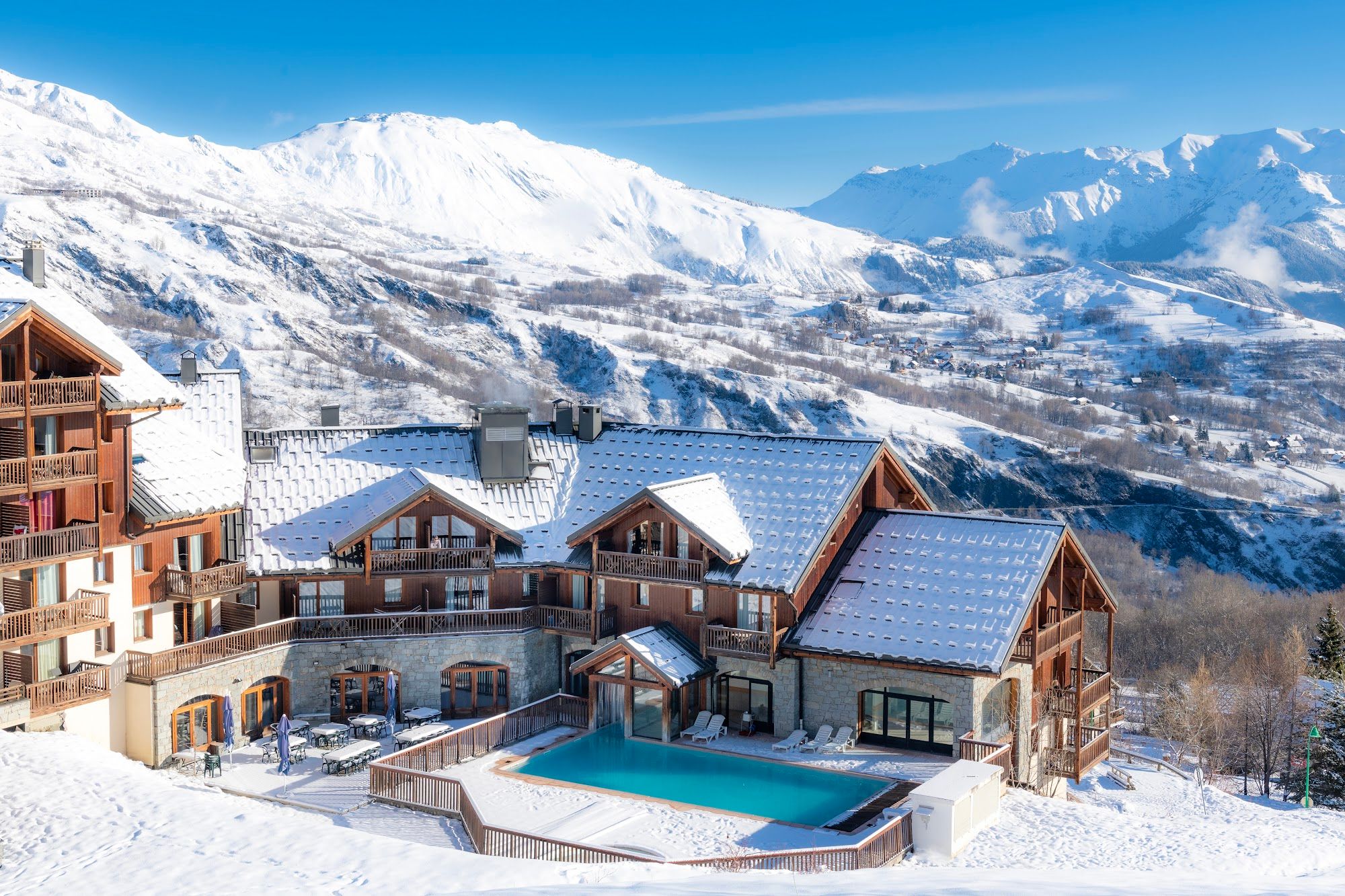 image Panoramic view of buildings and mountains covered in snow.