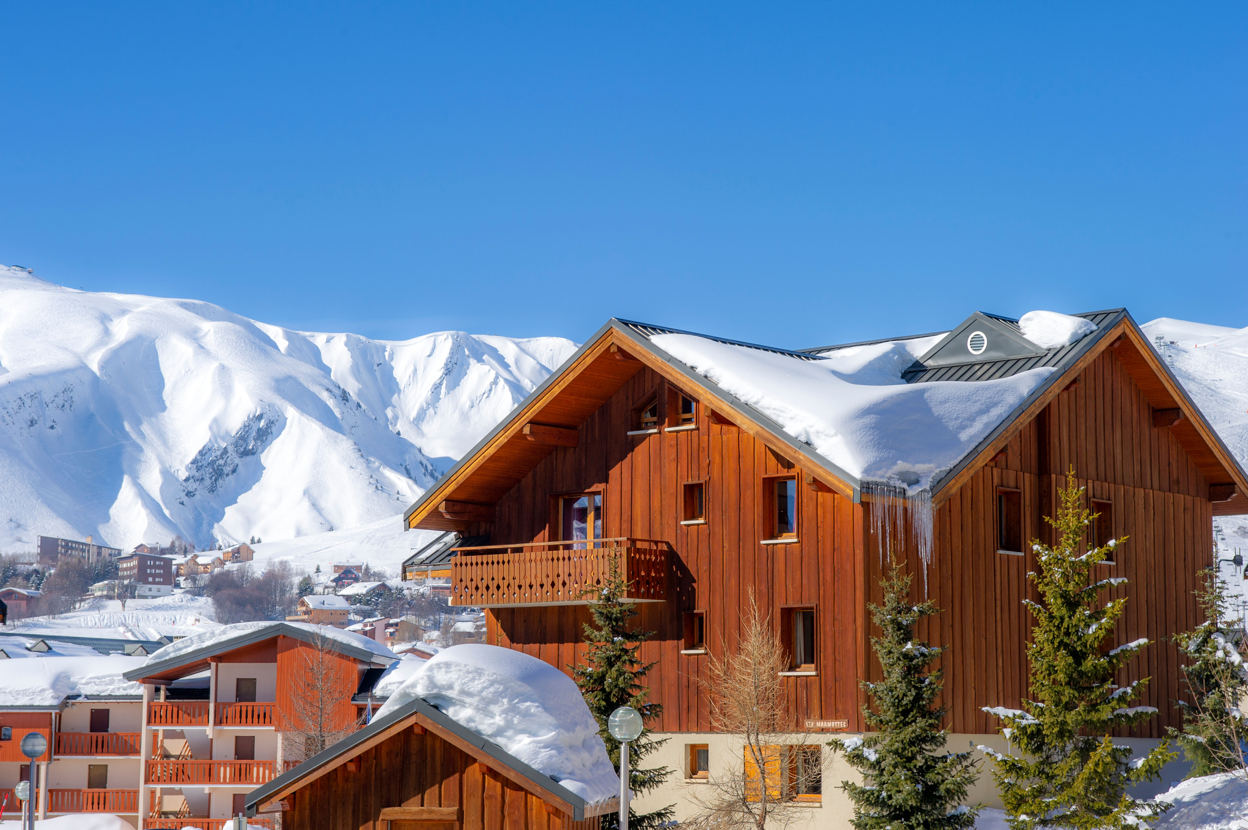 image Snow-covered chalets set against the surrounding peaks.