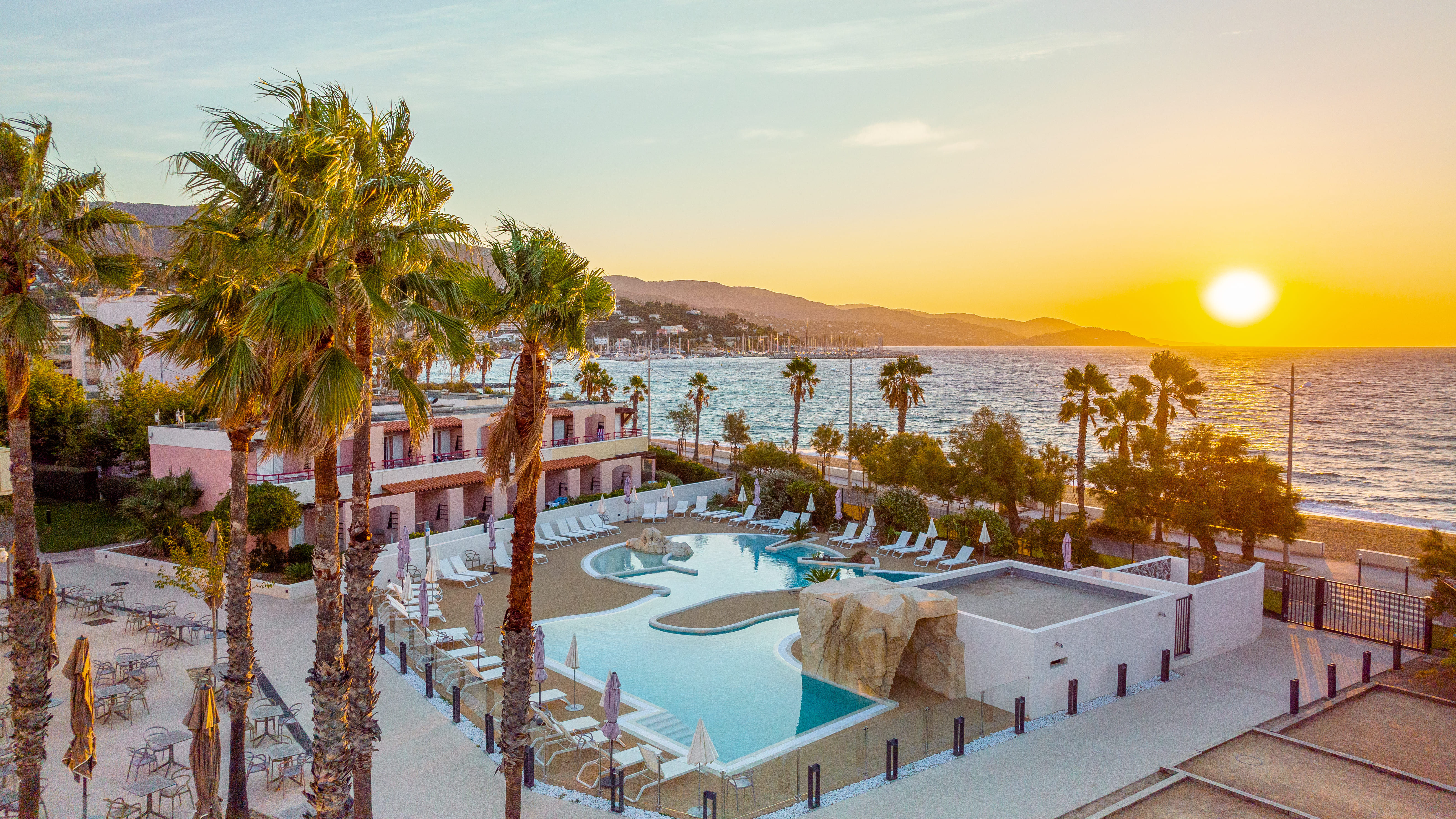 image Seasonal poolside lounging with ocean views nearby.