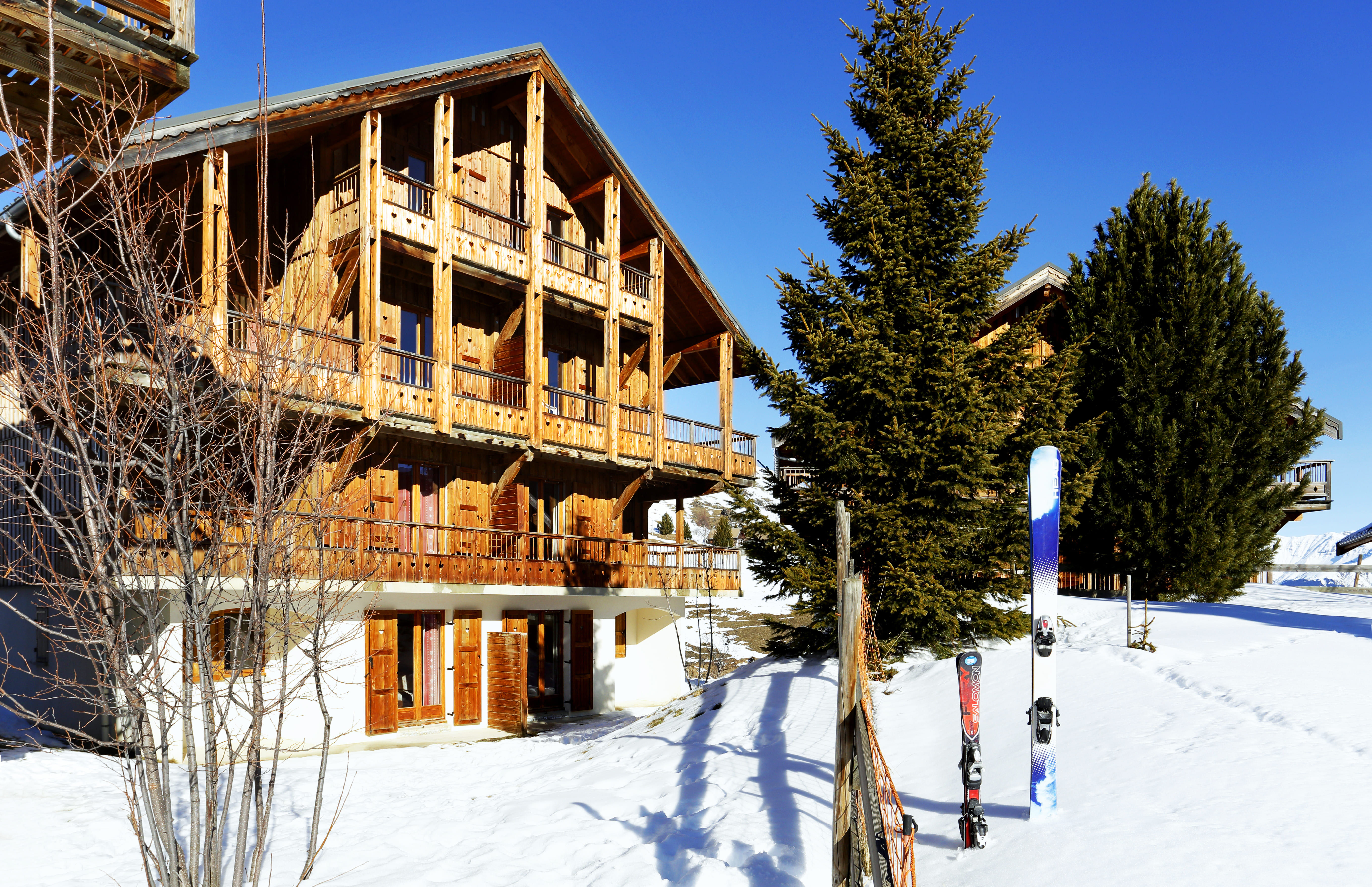 image Ski equipment next to snowy chalets.