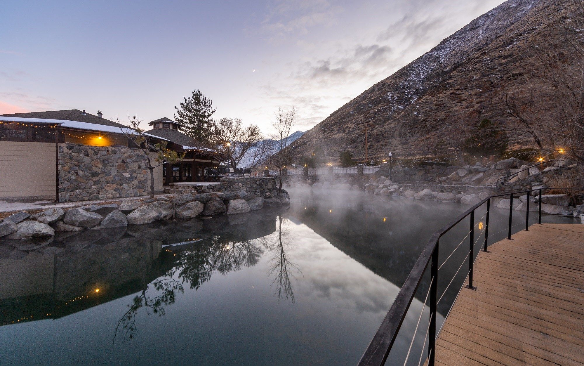 image Geothermal hot pools amid misty mountain scenery, available for an additional charge.