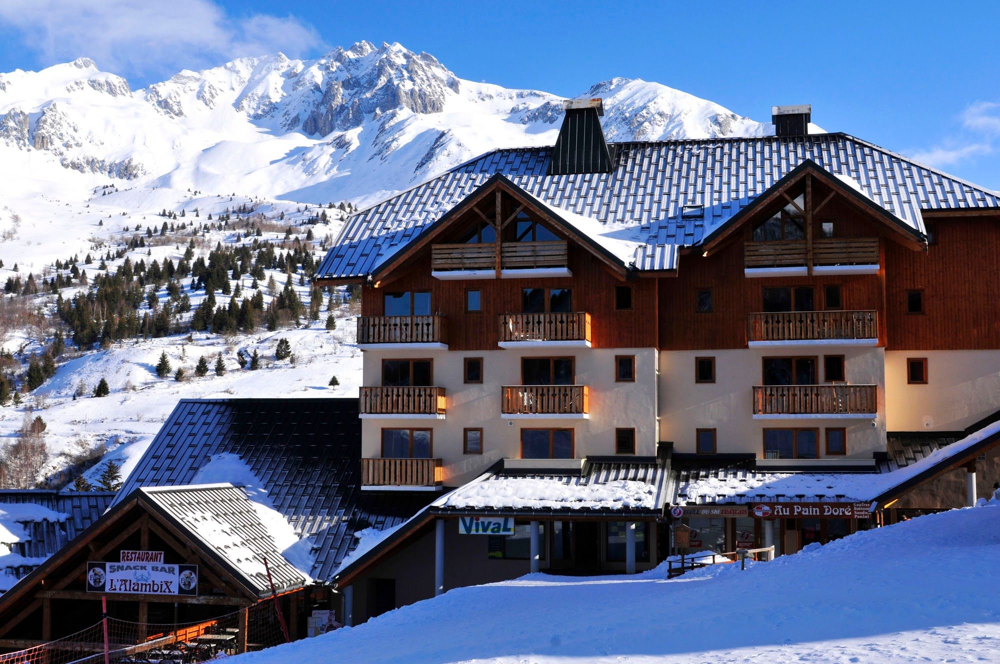 image Snow-covered building with mountains in background