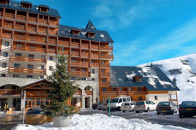 image Fresh snow surrounds the stone-based building with wooden balconies.