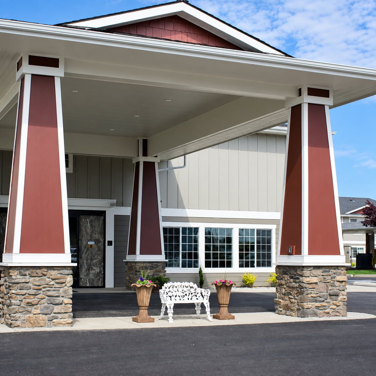 image Entrance with stone pillars and bench