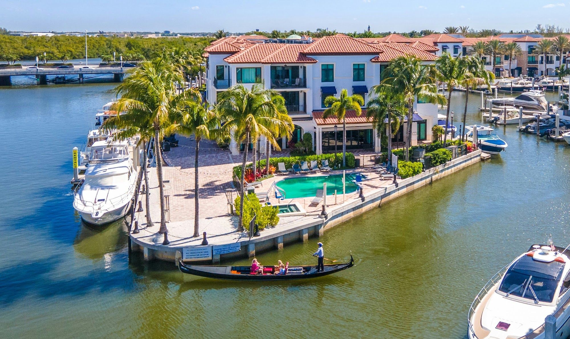 image Marina dock with boats and a waterfront pool area