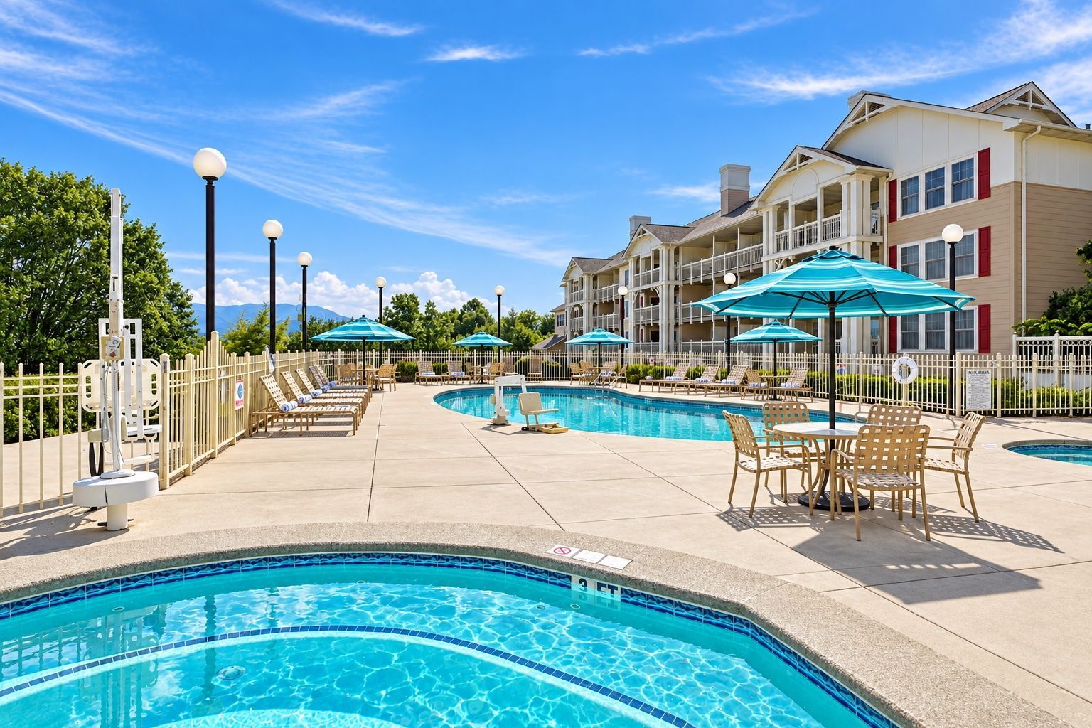 image Outdoor pool area with lounge chairs and multi-story building
