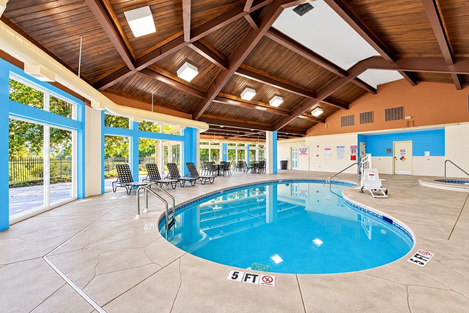 image Indoor pool area with surrounding seating and lounge chairs
