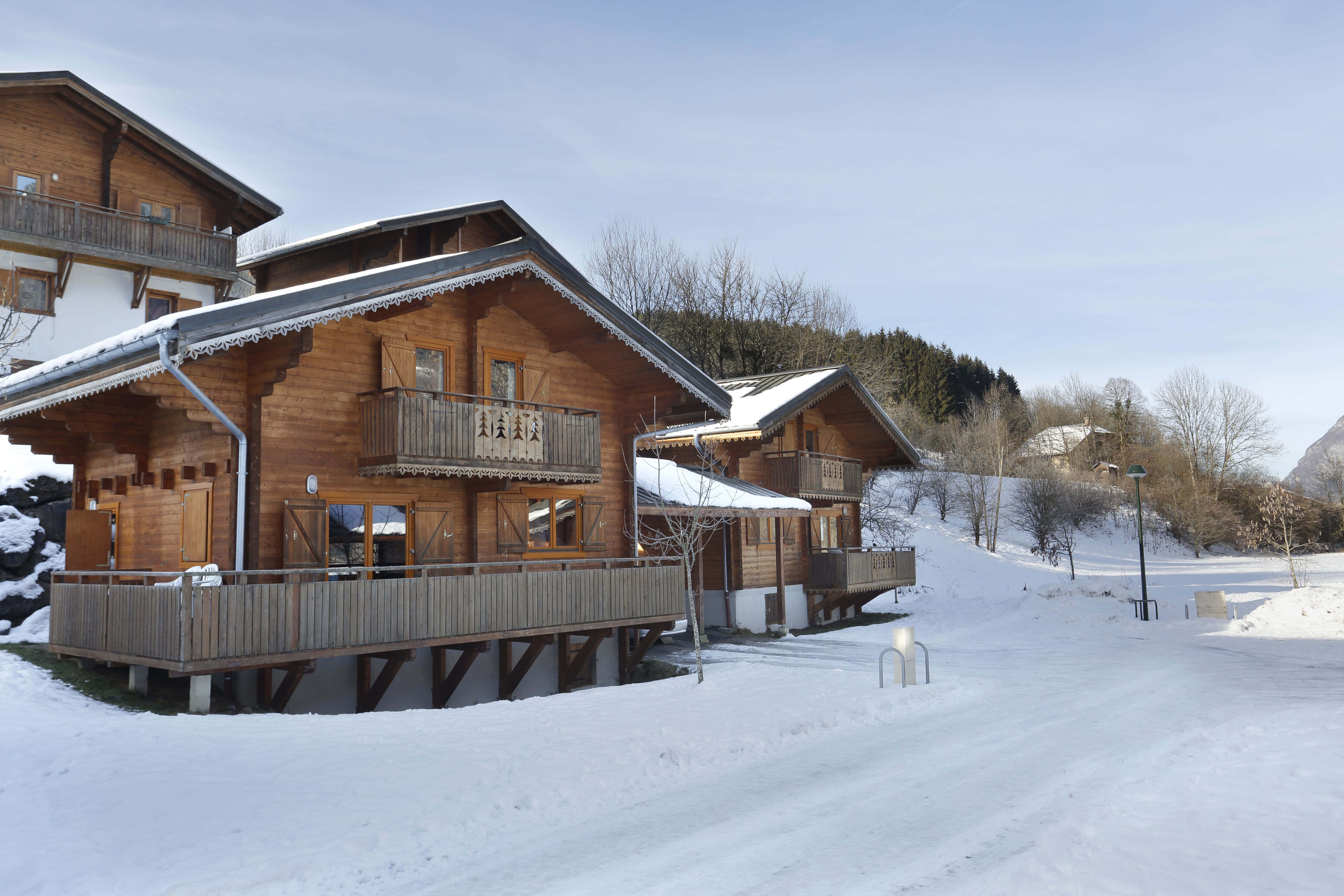 image Wide balconies overlook snow-covered hills and pine forest.