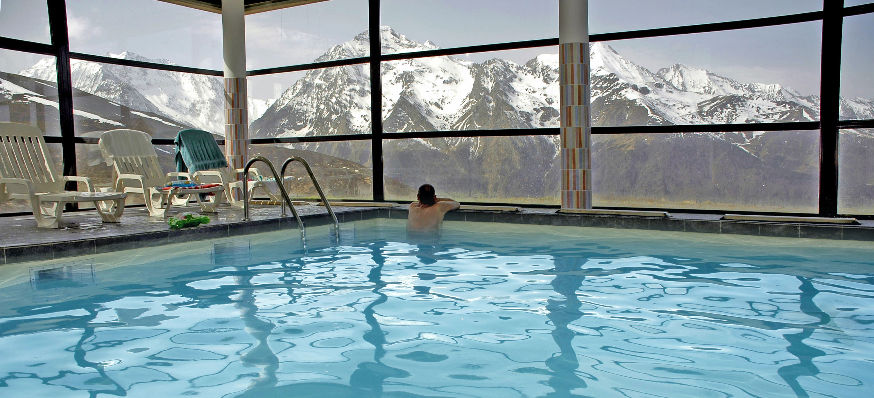 image Indoor swimming pool with mountain view through large windows