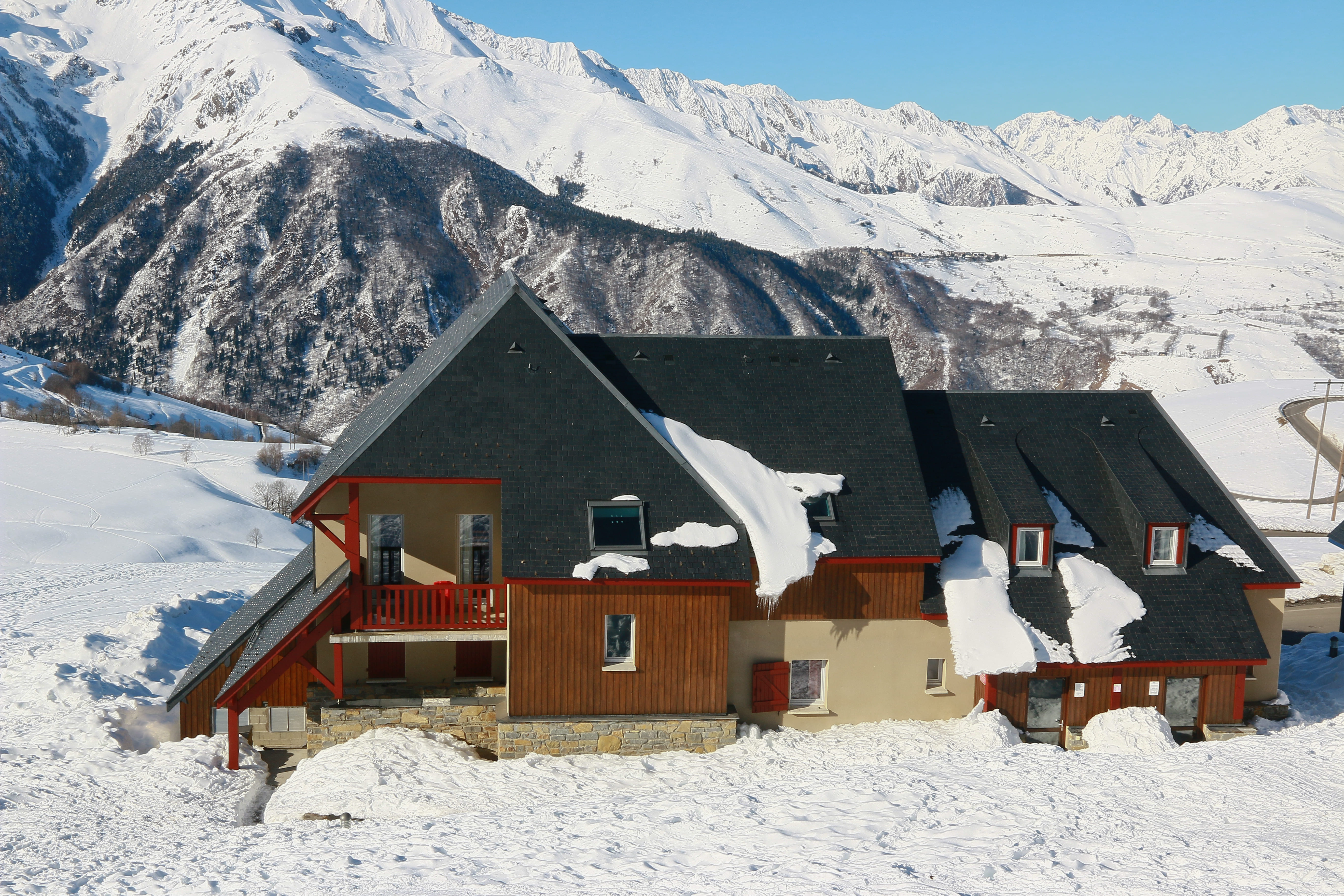 image Building structure surrounded by snow with mountains in the distance